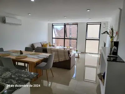 a living room with a table and a couch at plazaColon in Cordoba