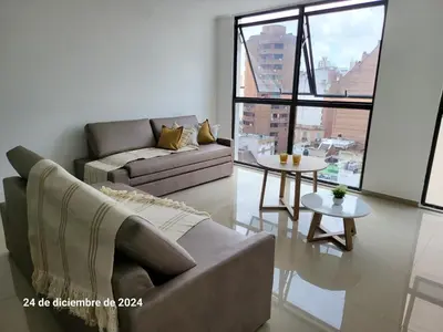 a living room with a couch and a table at plazaColon in Cordoba