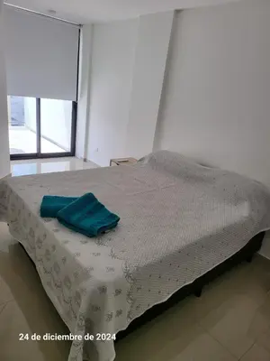 a bed with a blue towel on it in a room at plazaColon in Cordoba