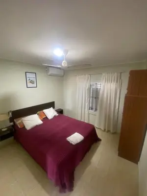 a bedroom with a large bed with a purple blanket at Don Nico in Cavalango