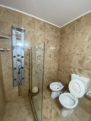 a bathroom with two toilets and a glass shower at Don Nico in Cavalango