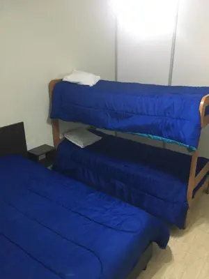 a room with three blue bunk beds in it at Don Nico in Cavalango