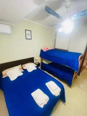 two beds in a room with blue sheets at Don Nico in Cavalango