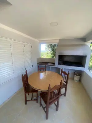a dining room with a wooden table and chairs at Don Nico in Cavalango