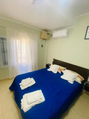 a bedroom with a blue bed with towels on it at Don Nico in Cavalango