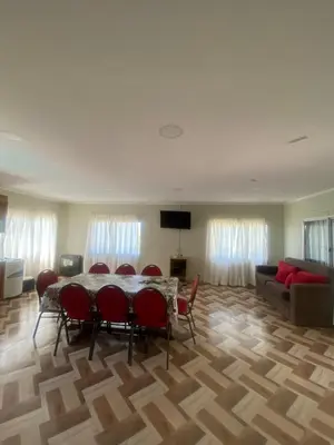a living room with a table and chairs and a couch at Don Nico in Cavalango