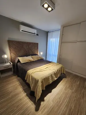 a bedroom with a large bed and a window at Dpto Ituzaingo 1270 - 2 dormitorios in Cordoba