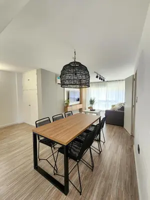 a dining room table and chairs in a living room at Dpto Ituzaingo 1270 - 2 dormitorios in Cordoba