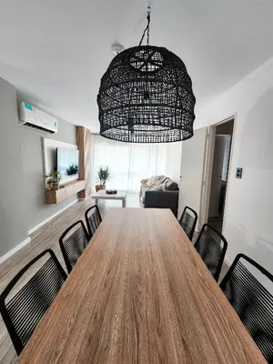 a dining room with a large wooden table and chairs at Dpto Ituzaingo 1270 - 2 dormitorios in Cordoba