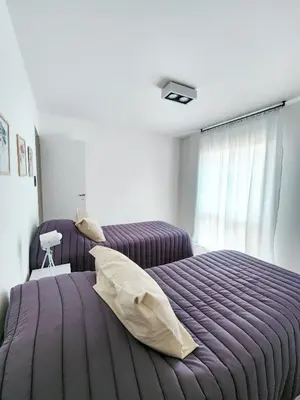 a bedroom with a purple bed and a window at Dpto Ituzaingo 1270 - 2 dormitorios in Cordoba