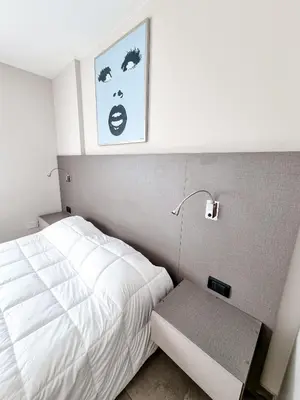 a small bedroom with a bed and a lamp at Dpto ituzaingo 741 - 1 dormitorio in Cordoba
