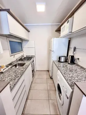 a kitchen with a sink and a refrigerator at Dpto ituzaingo 741 - 1 dormitorio in Cordoba