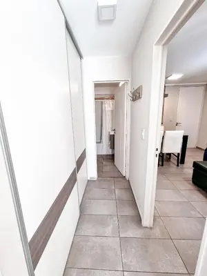 a hallway with white walls and a tile floor at Dpto ituzaingo 741 - 1 dormitorio in Cordoba