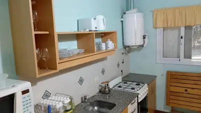 a small kitchen with a stove and a sink at Las icarias in Las Calles