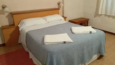 a bedroom with a bed with two towels on it at Las icarias in Las Calles