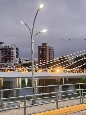 a street light on a bridge over a body of water at Departamento en Torre Serena in Villa Carlos Paz