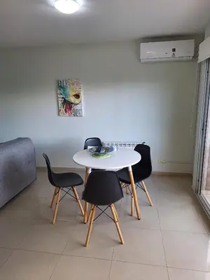 a white table and chairs in a living room at Departamento en Torre Serena in Villa Carlos Paz