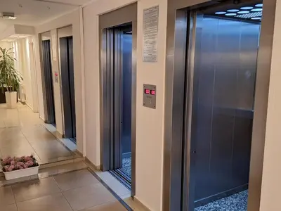 a row of elevators in a hallway in a building at Departamento en Torre Serena in Villa Carlos Paz
