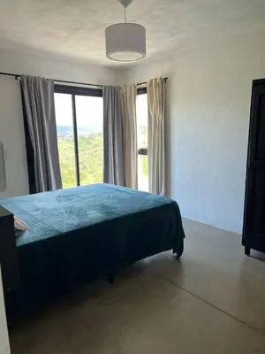 a bedroom with a bed and a large window at El Paisaje in Villa Parque Siquiman