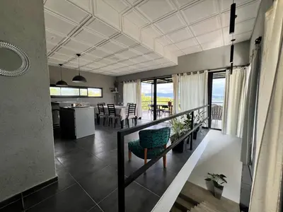 a living room with a kitchen and a dining room at El Paisaje in Villa Parque Siquiman