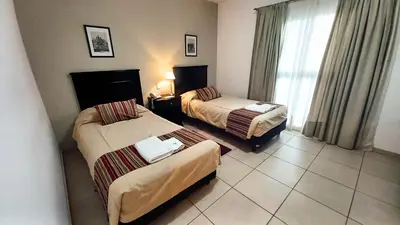 a hotel room with two beds and a window at Laplace Hotel in Cordoba