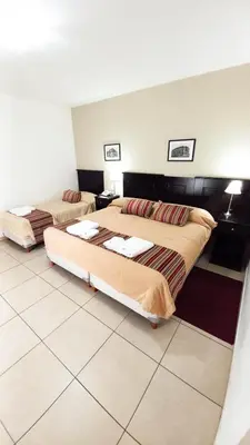 a room with two beds in a room at Laplace Hotel in Cordoba