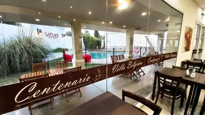 a dining room with tables and chairs and a restaurant at Laplace Hotel in Cordoba