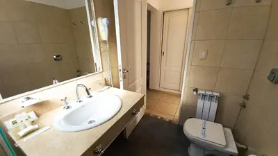 a bathroom with a sink and a toilet at Laplace Hotel in Cordoba