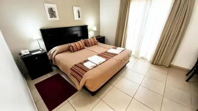a bedroom with a large bed with two towels on it at Laplace Hotel in Cordoba