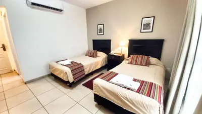a hotel room with two beds in a room at Laplace Hotel in Cordoba