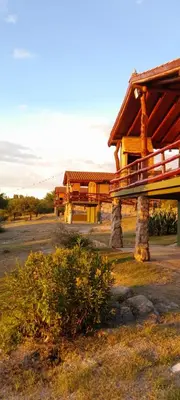 a building with a bench in front of it at Vista al río 2 dormitorios in Arroyo de Los Patos