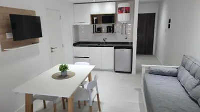 a kitchen and living room with a table and a couch at Miralejos 16 Apartamento in Villa Carlos Paz
