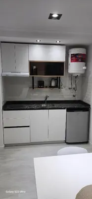 a kitchen with white cabinets and a counter top at Miralejos 16 Apartamento in Villa Carlos Paz