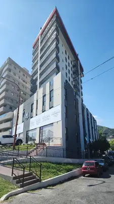 a building with a car parked in front of it at Miralejos 16 Apartamento in Villa Carlos Paz