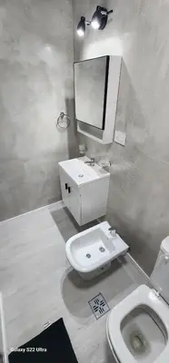 a bathroom with a sink and a toilet and a mirror at Miralejos 16 Apartamento in Villa Carlos Paz