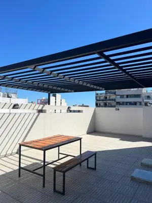 a bench and a table on top of a roof at Alta Córdoba Nook in Cordoba