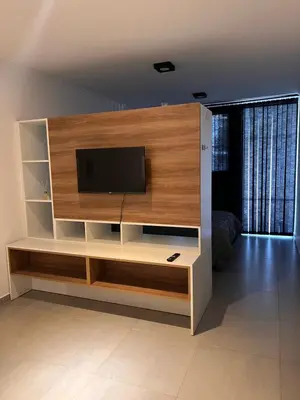 a large entertainment center with a flat screen tv at Alta Córdoba Nook in Cordoba