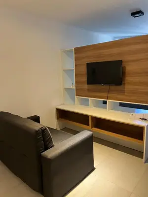 a living room with a couch and a flat screen tv at Alta Córdoba Nook in Cordoba