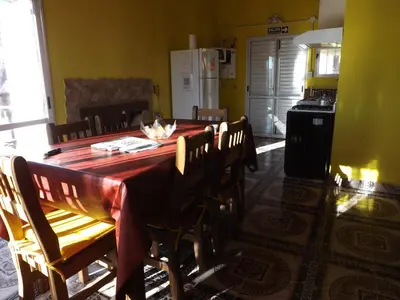 a dining room table with a cat sitting on top of it at Cabañas San Jose in Potrero de Garay