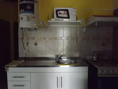a kitchen with a sink and a microwave at Cabañas San Jose in Potrero de Garay