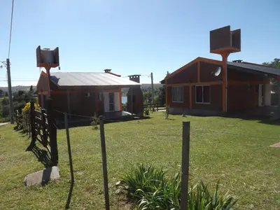 a house with a fence in front of it at Cabañas San Jose in Potrero de Garay
