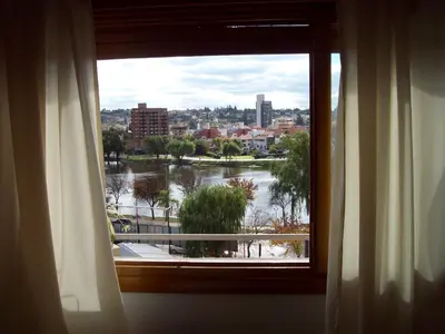 a window in a room with a view of a river at CARLOS PAZ, Dpto, 3 Huésped in Villa Carlos Paz