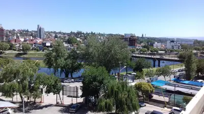 a view of a city with a river and buildings at CARLOS PAZ, Dpto, 3 Huésped in Villa Carlos Paz