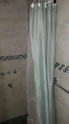 a shower with a shower curtain in a bathroom at CARLOS PAZ, Dpto, 3 Huésped in Villa Carlos Paz
