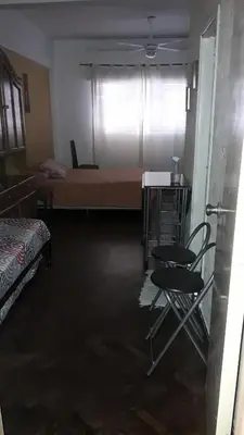 a room with a bed and a table and chairs at CARLOS PAZ, Dpto, 3 Huésped in Villa Carlos Paz
