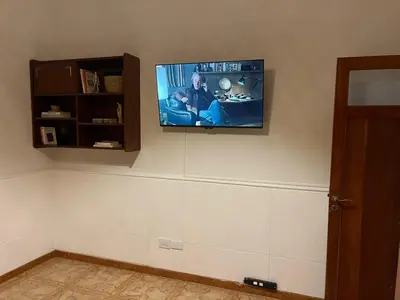 a flat screen tv hanging on a wall at Casa Criselo Multiespacio in Cordoba