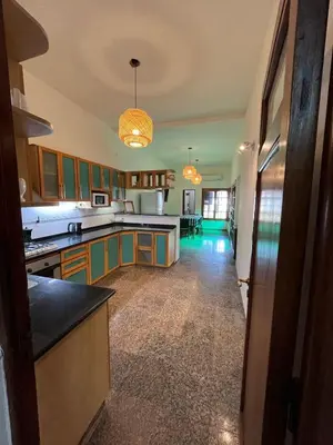a kitchen with green cabinets and a counter top at Casa Criselo Multiespacio in Cordoba