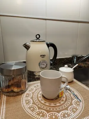 a table with a tea pot and cups on a counter at Nova Apartament in Cordoba