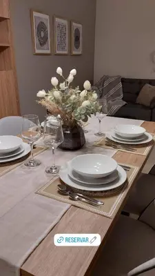a dining room table with plates and glasses on it at Nova Apartament in Cordoba