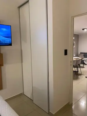 a sliding glass door with a television on a wall at Nova Apartament in Cordoba